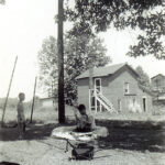 After 1945 - from the west in the yard of the home that served as the plant manager's residence looking toward the horse barn/employee changing area.