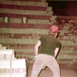 Unknow "tosser" filling a kiln for firing in the 1980s. Name? If you know, please email us.