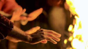 warming hands by fire